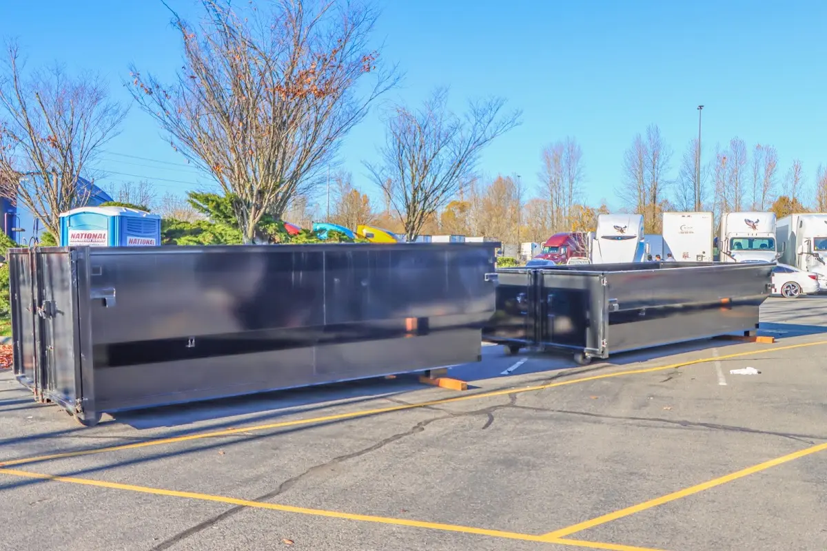 Professional dumpster rental service with roll-off container on residential driveway in Ville Platte